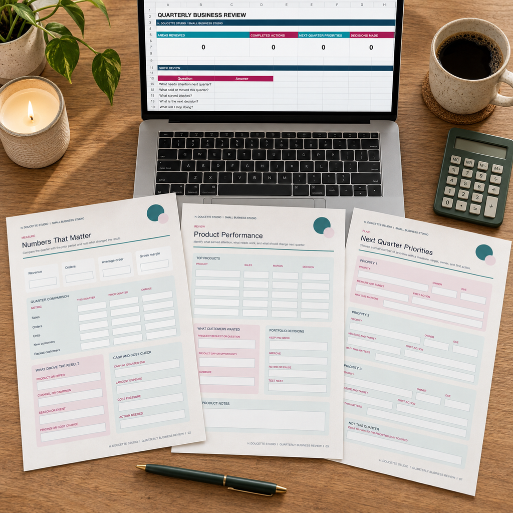 Quarterly Review PDF pages and Excel dashboard arranged on a small business desk