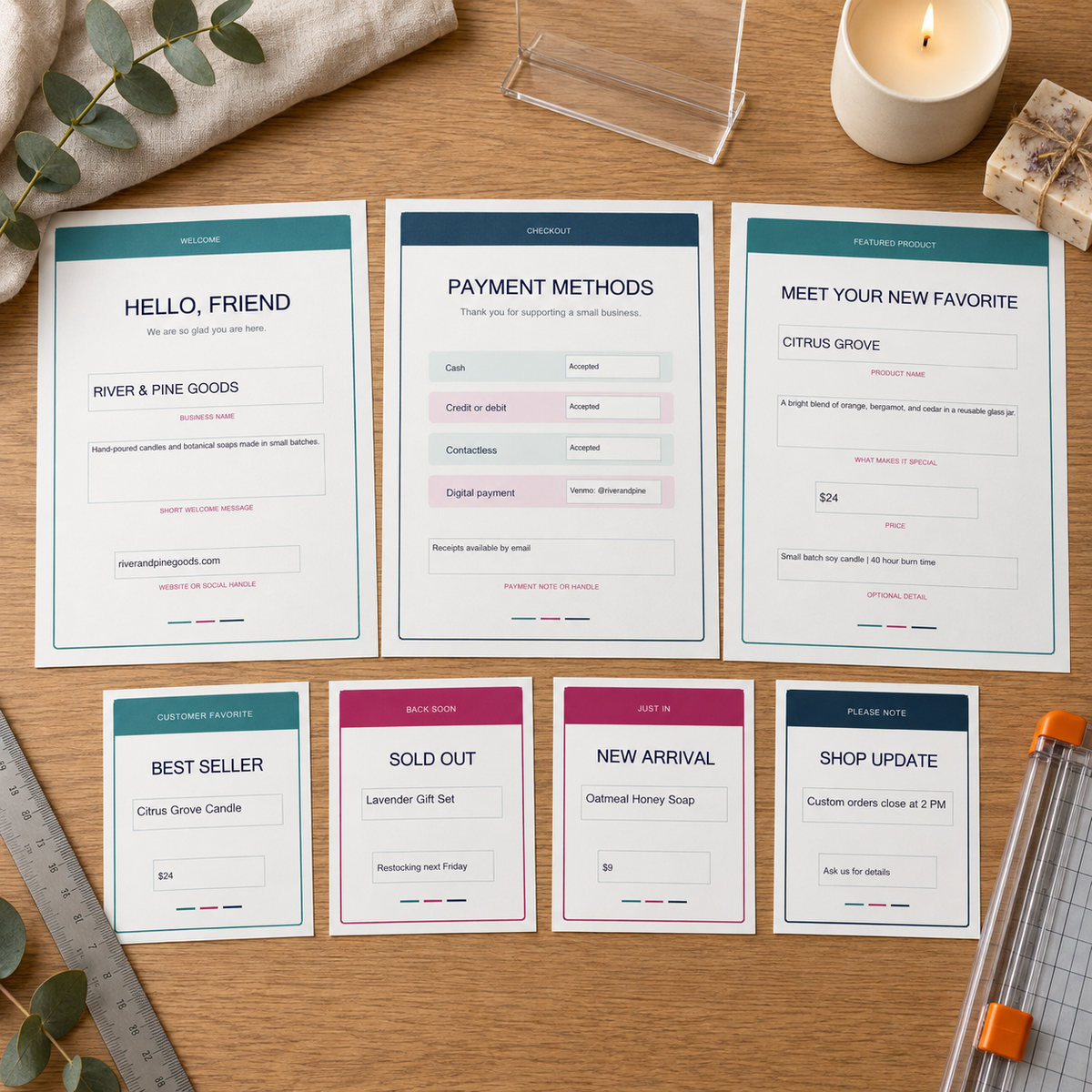 Complete Small Business Signage Kit with printable full-page signs and tabletop cards arranged on a studio desk